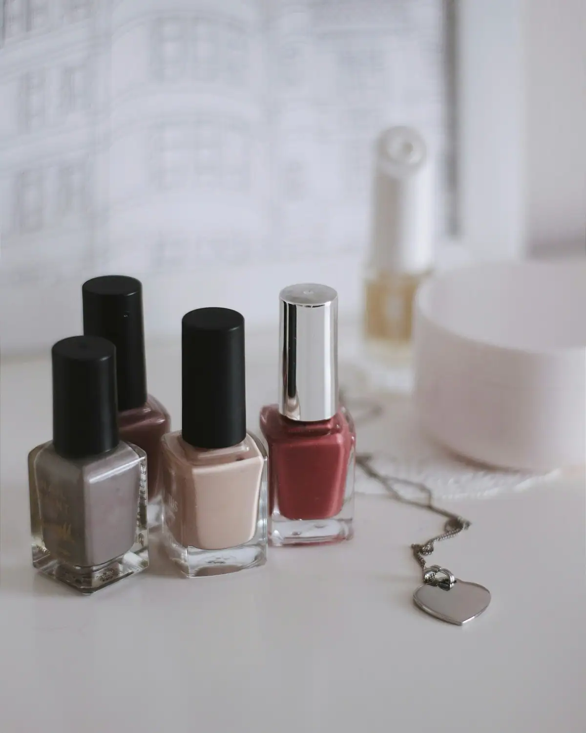 Nail polish bottles in nude and burgundy shades