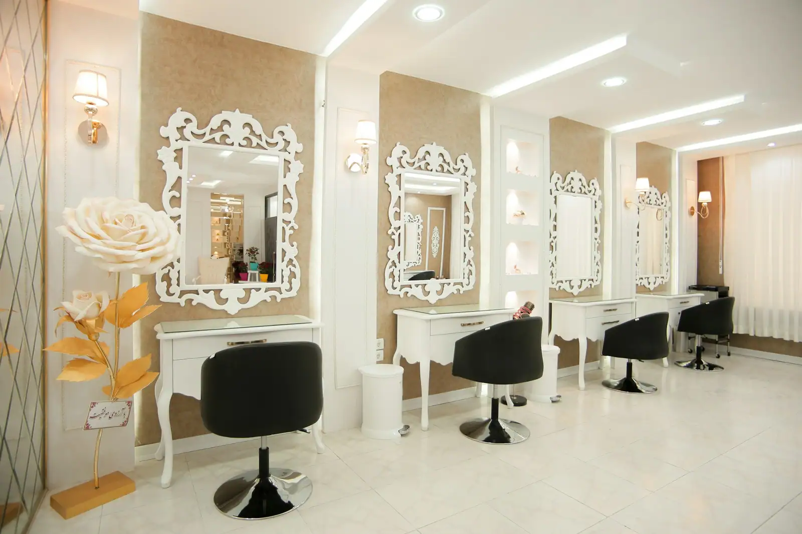 The salon's hair area with white-framed mirrors and vanity tables