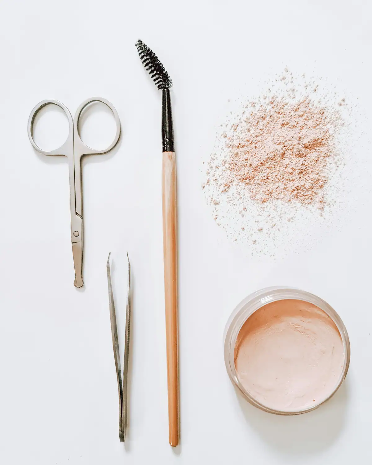 Brow scissors, tweezers, a brow brush and powder